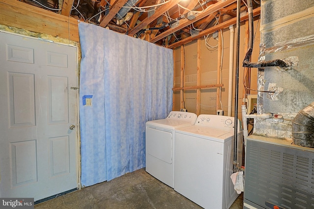 clothes washing area with washer and dryer and heating unit