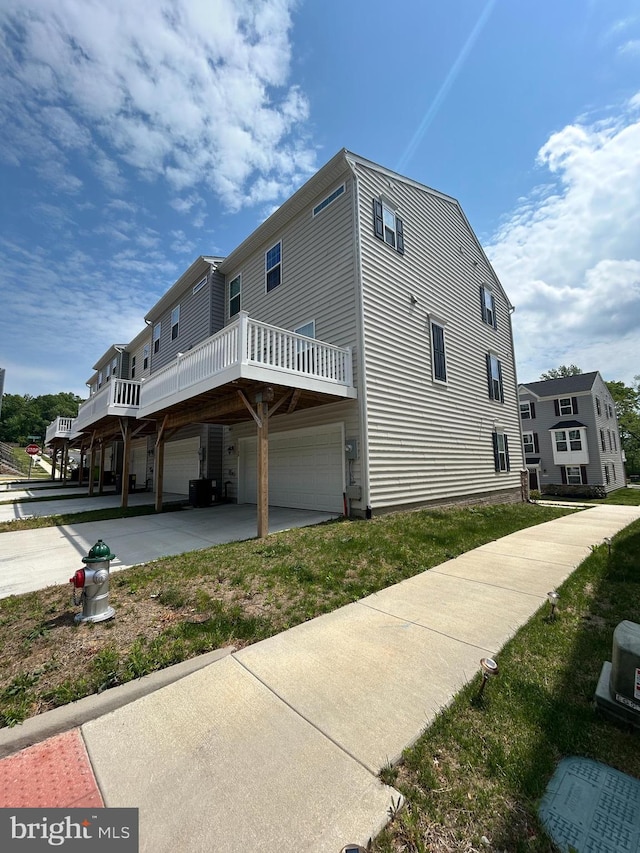 view of home's exterior with a garage and concrete driveway