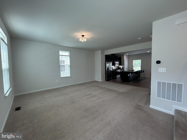 1108 Dovetail Cir, Fredericksburg, VA 22401 - unfurnished living room with light carpet and baseboards