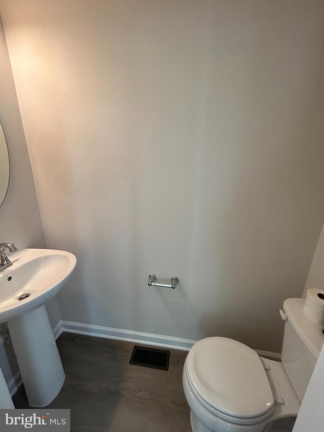 1108 Dovetail Cir, Fredericksburg, VA 22401 - half bathroom with toilet, baseboards, and a sink