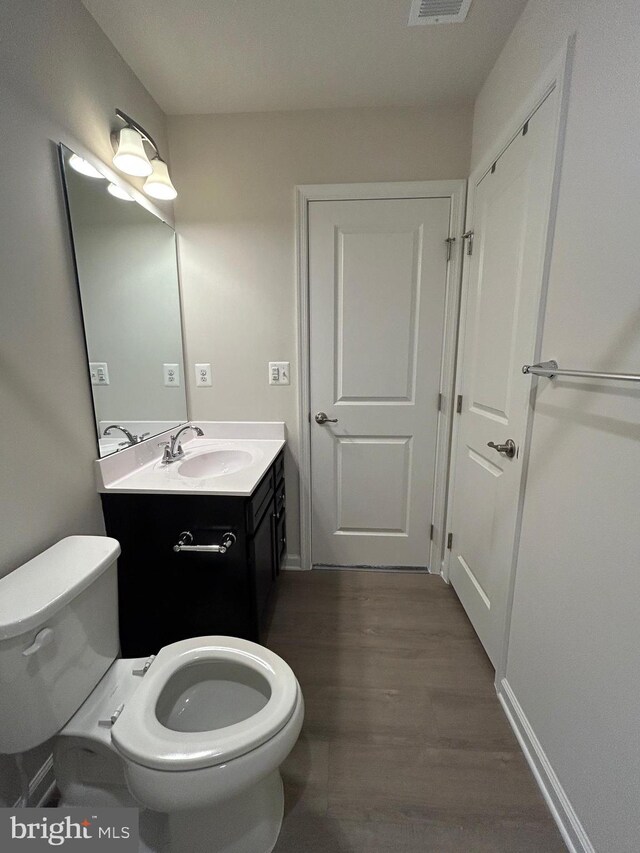 1108 Dovetail Cir, Fredericksburg, VA 22401 - half bathroom featuring toilet, wood finished floors, vanity, and baseboards