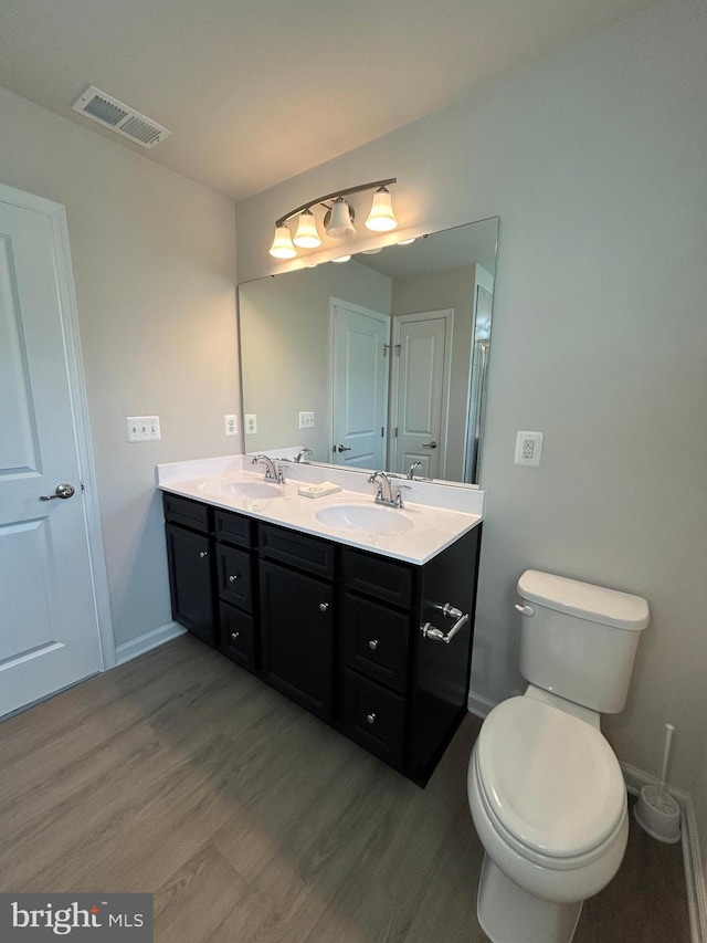 1108 Dovetail Cir, Fredericksburg, VA 22401 - full bathroom featuring wood finished floors, double vanity, baseboards, and toilet