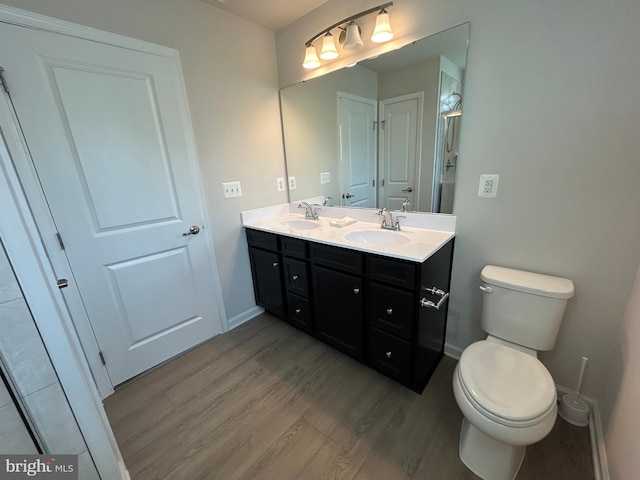 1108 Dovetail Cir, Fredericksburg, VA 22401 - bathroom featuring wood finished floors, baseboards, toilet, and double vanity