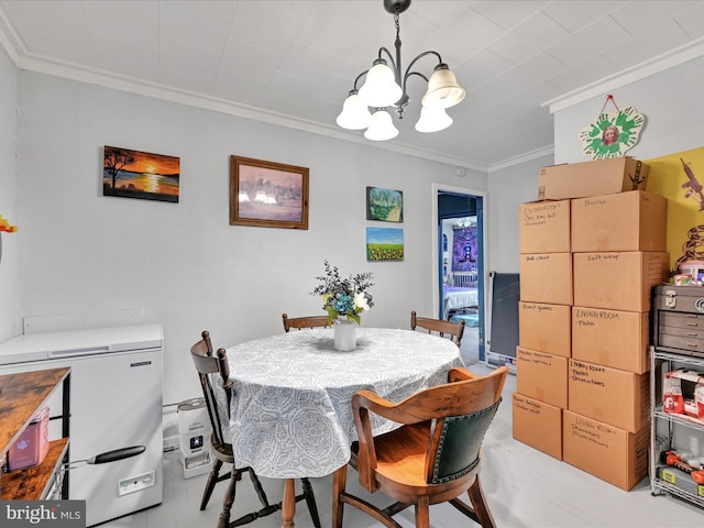 dining area with ornamental molding and a notable chandelier