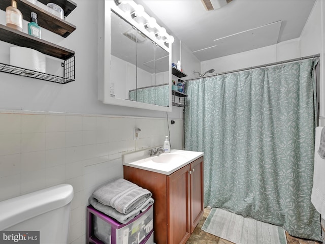 bathroom with toilet, a shower with curtain, tile walls, and vanity