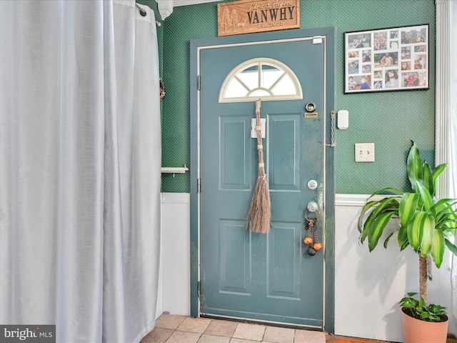 tiled entryway with wallpapered walls