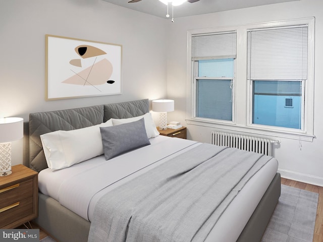 1523 17th St SE, Washington, DC 20020 - bedroom featuring radiator, wood finished floors, and baseboards