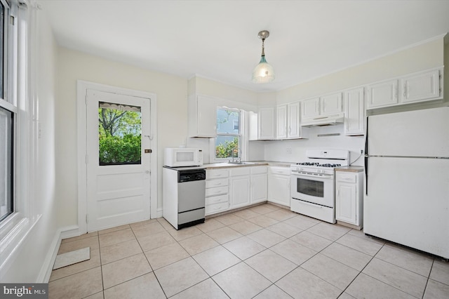 kitchen with under cabinet range hood, plenty of natural light, white cabinets, and white appliances