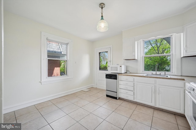 kitchen with dishwashing machine, a sink, a wealth of natural light, white microwave, and light countertops