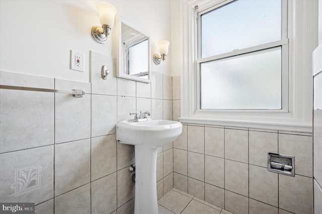 bathroom with tile walls and a sink