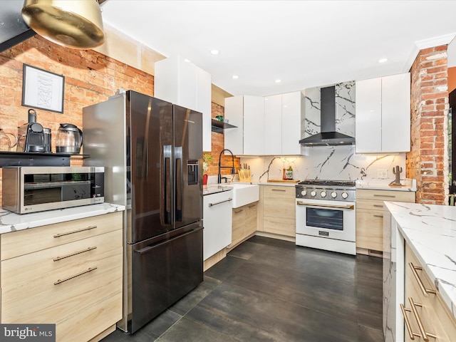 kitchen with wall chimney exhaust hood, stainless steel appliances, a sink, modern cabinets, and decorative backsplash