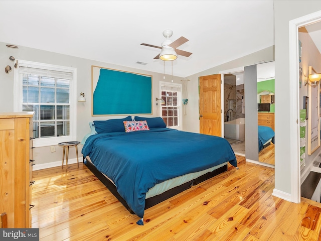 bedroom featuring light wood finished floors, baseboards, and a ceiling fan