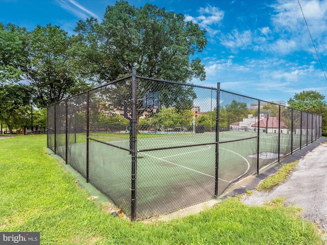 view of tennis court featuring community basketball court