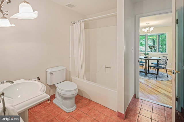 full bath featuring visible vents, shower / bath combo, baseboards, toilet, and a notable chandelier