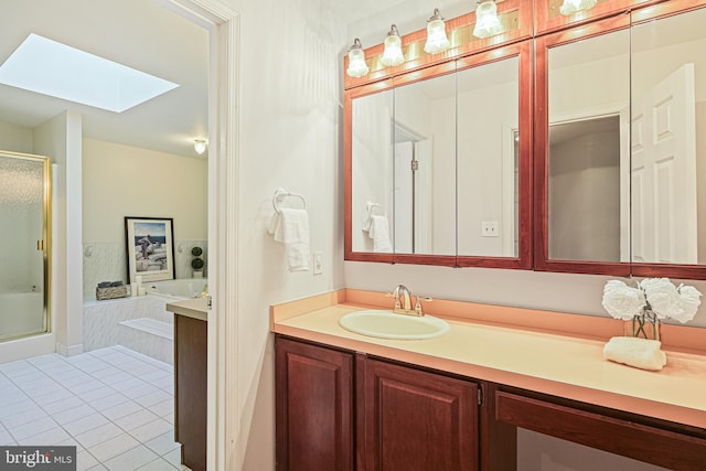 bathroom with a skylight, a shower stall, tile patterned floors, and vanity