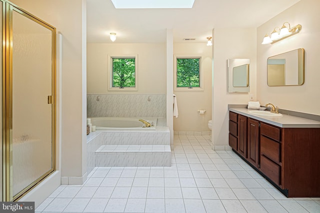 full bathroom featuring tile patterned flooring, vanity, toilet, a garden tub, and a stall shower