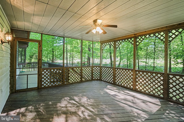 unfurnished sunroom with a ceiling fan