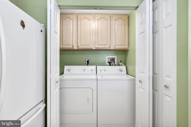 clothes washing area with cabinet space and washing machine and clothes dryer