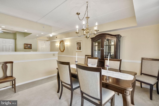 dining space featuring baseboards, carpet flooring, and a chandelier