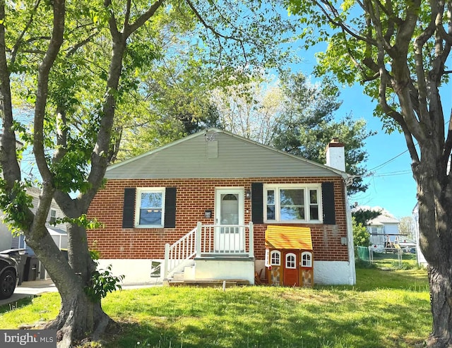 918 Hillside Ave, Upper Chichester, PA 19061 - bungalow-style house featuring brick siding, fence, a front yard, and a chimney