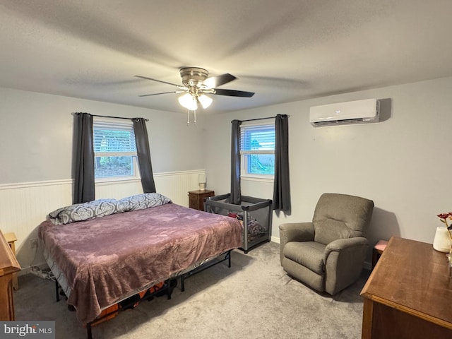918 Hillside Ave, Upper Chichester, PA 19061 - bedroom featuring a ceiling fan, wainscoting, carpet flooring, and a wall mounted air conditioner