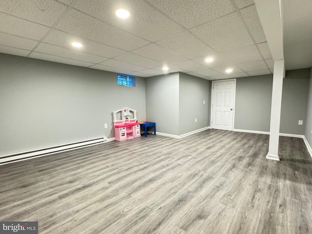 918 Hillside Ave, Upper Chichester, PA 19061 - rec room with wood finished floors, baseboards, a drop ceiling, recessed lighting, and a baseboard radiator