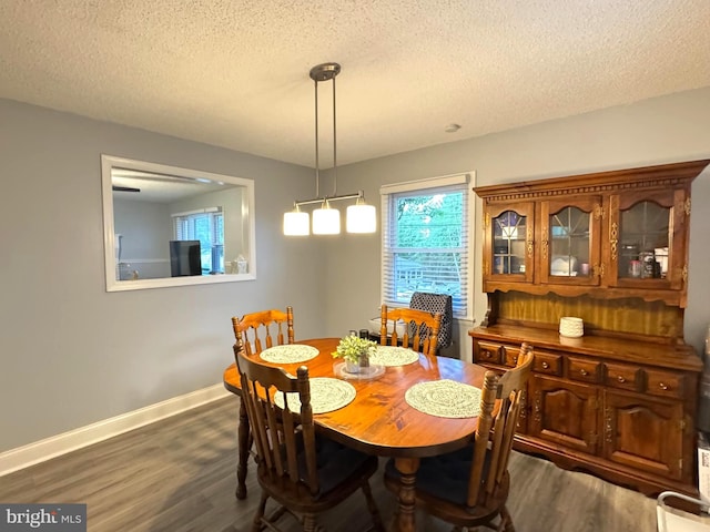 918 Hillside Ave, Upper Chichester, PA 19061 - dining space featuring dark wood-type flooring, a textured ceiling, and baseboards