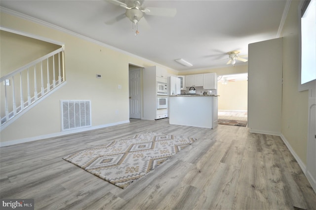 100 Watertown Rd, Ocean Pines, MD 21811 - unfurnished living room with stairway, ceiling fan, visible vents, light wood-style flooring, and baseboards