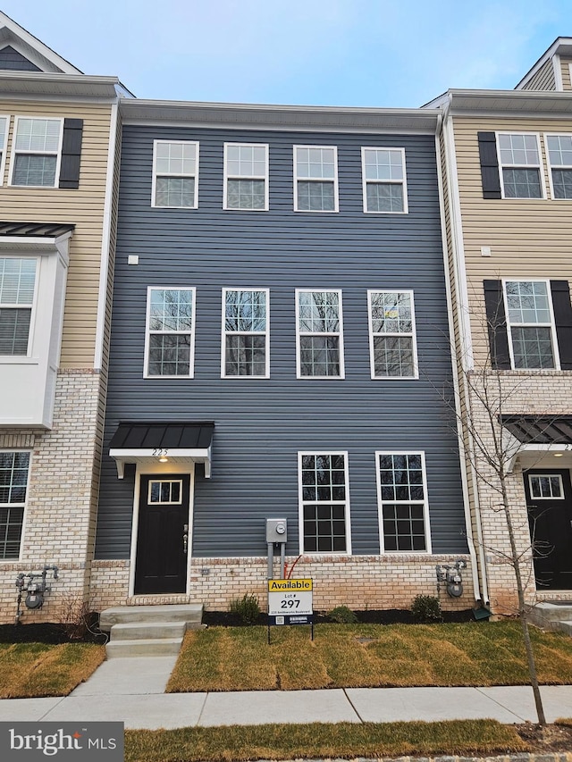 view of property with brick siding