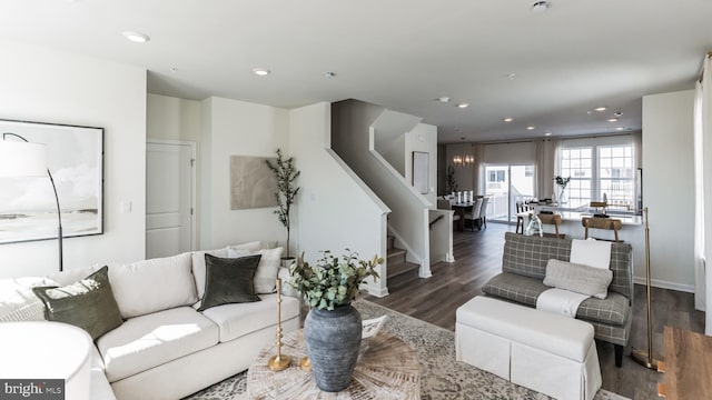 living area with recessed lighting, stairway, wood finished floors, and baseboards