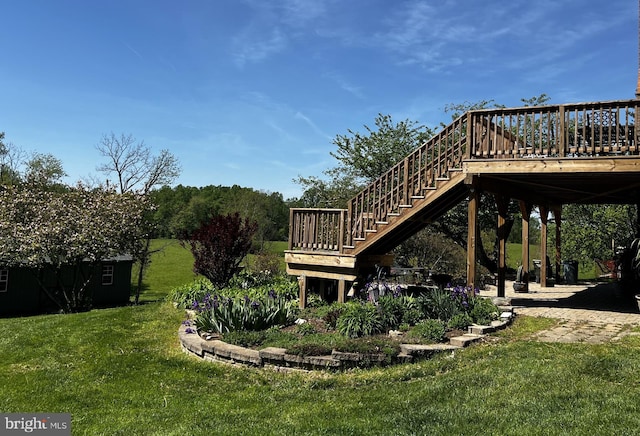view of yard with a deck and stairway