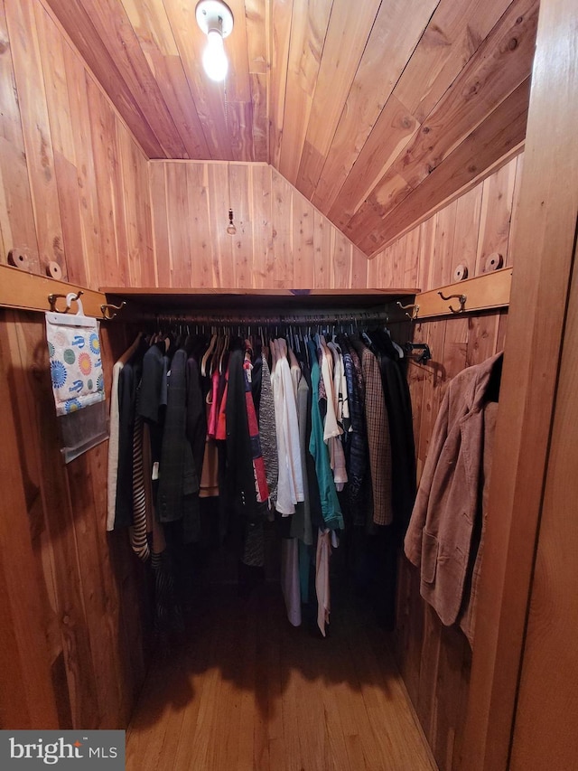 spacious closet with lofted ceiling and hardwood / wood-style floors