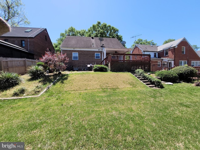 rear view of property with a wooden deck and stairs