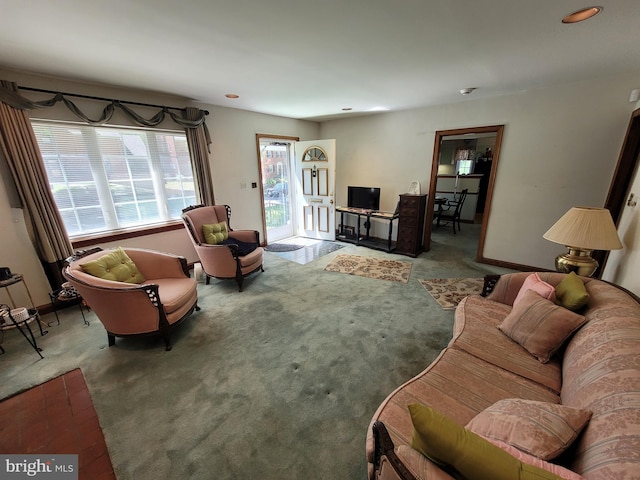 carpeted living room with baseboards