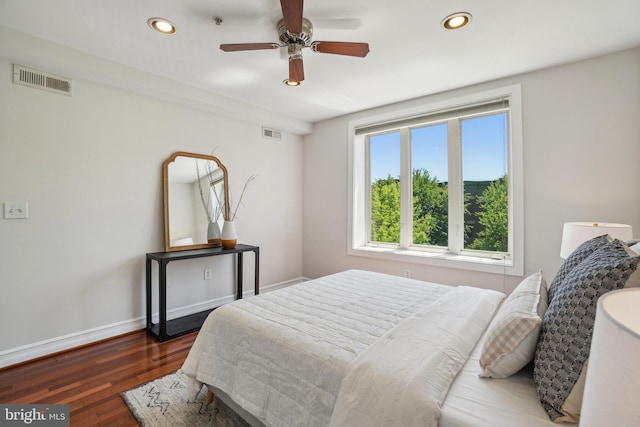 bedroom with baseboards, recessed lighting, wood finished floors, and visible vents