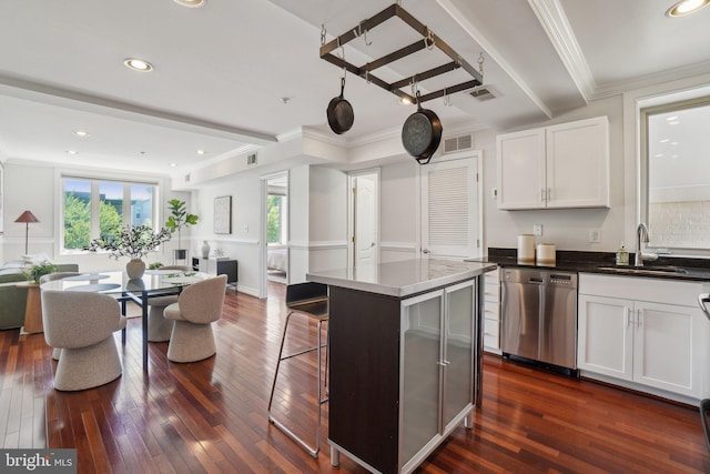 kitchen with stainless steel dishwasher, open floor plan, visible vents, and a sink
