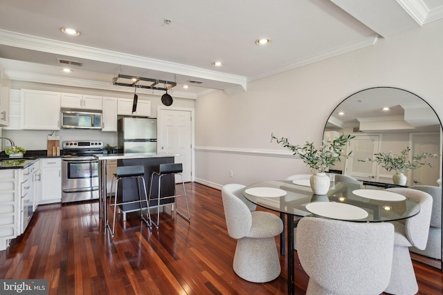dining area with visible vents, ornamental molding, dark wood finished floors, and recessed lighting