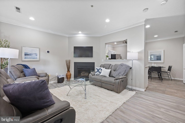 4006 Enders Ln, Bowie, MD 20716 - living area with recessed lighting, a glass covered fireplace, baseboards, light wood-type flooring, and ornamental molding