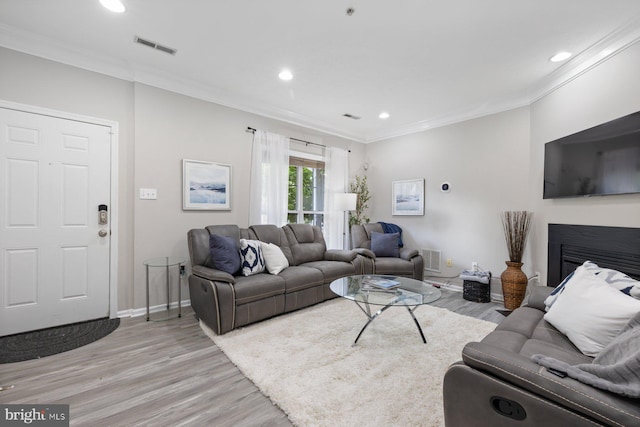 4006 Enders Ln, Bowie, MD 20716 - living room with light wood-type flooring, recessed lighting, crown molding, baseboards, and a glass covered fireplace