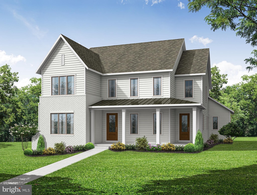 view of front facade with a shingled roof, a front lawn, metal roof, and a standing seam roof