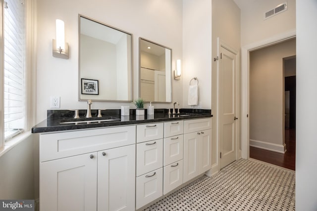 1830 Rittenhouse Sq Unit 1E, Philadelphia, PA 19103 - bathroom with baseboards, visible vents, double vanity, and a sink