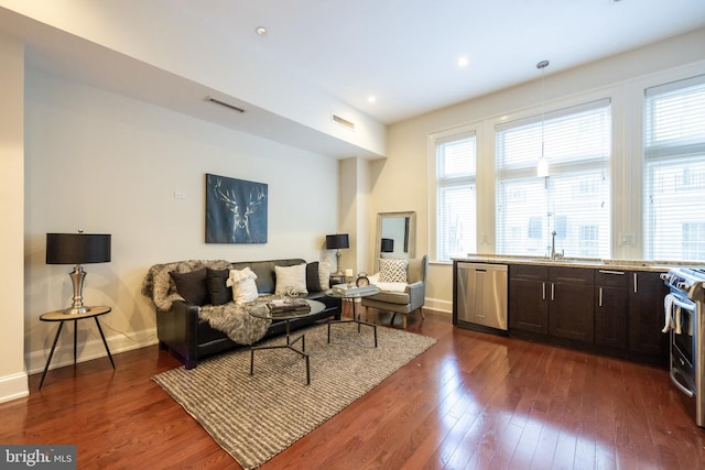 1830 Rittenhouse Sq Unit 1E, Philadelphia, PA 19103 - living area featuring dark wood-style flooring, a wealth of natural light, baseboards, and visible vents