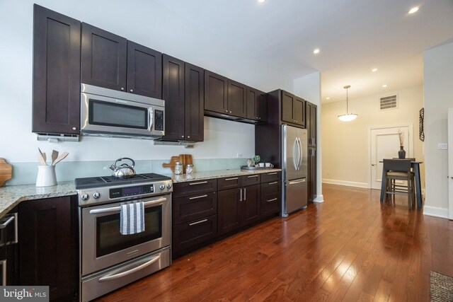 1830 Rittenhouse Sq Unit 1E, Philadelphia, PA 19103 - kitchen featuring visible vents, dark wood-type flooring, light stone countertops, appliances with stainless steel finishes, and recessed lighting