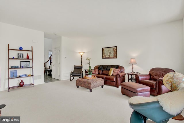 living room with stairway and carpet