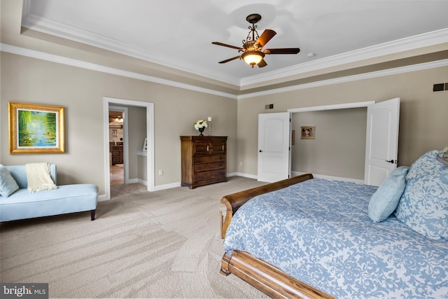 bedroom featuring ornamental molding, a tray ceiling, and light carpet