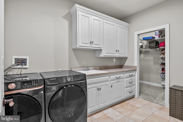 laundry room with cabinet space, independent washer and dryer, light tile patterned flooring, light carpet, and a sink