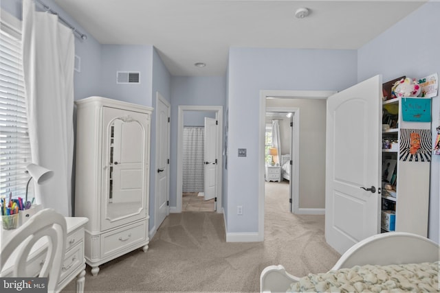 bedroom featuring light colored carpet, baseboards, and visible vents