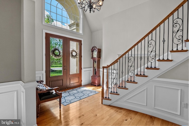 foyer featuring an inviting chandelier, a wainscoted wall, and a decorative wall