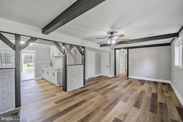 1640 Kreitler Valley Rd, Forest Hill, MD 21050 - unfurnished living room featuring a sink, baseboards, plenty of natural light, and a textured ceiling