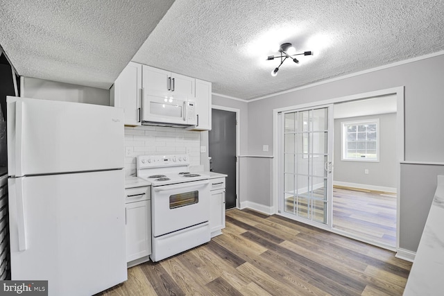 1640 Kreitler Valley Rd, Forest Hill, MD 21050 - kitchen with wood finished floors, white appliances, a textured ceiling, white cabinets, and backsplash